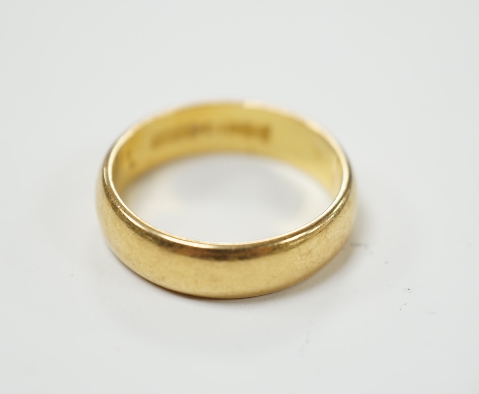 A 22ct gold wedding band, size K/L, 5 grams. Fair condition.